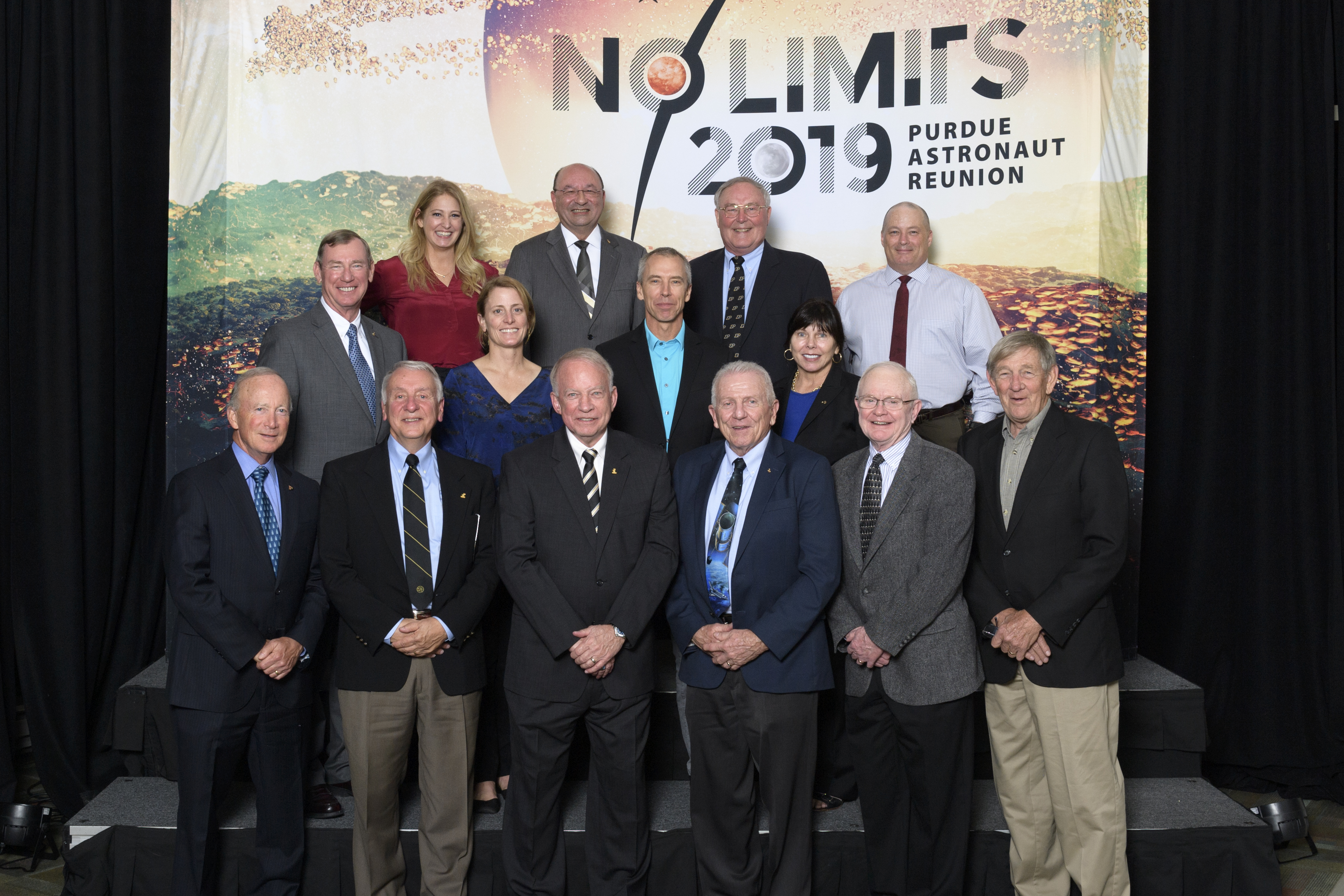 Purdue President Mitch Daniels poses with alumni astronauts who returned to campus for homecoming 2019